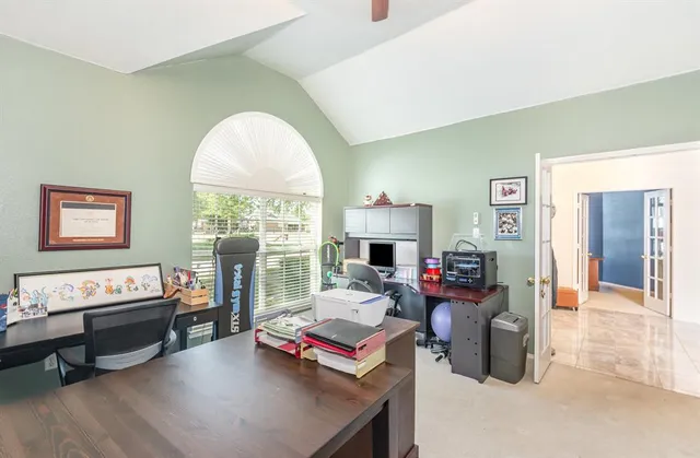 a living room with furniture fireplace and a large window