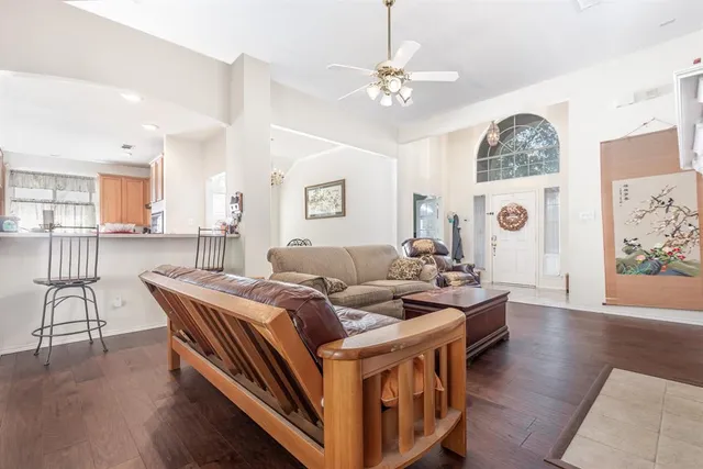 a living room with furniture and wooden floor