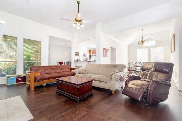 a living room with furniture and wooden floor