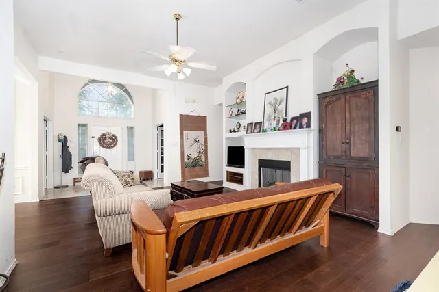 a living room with furniture a fireplace and a chandelier
