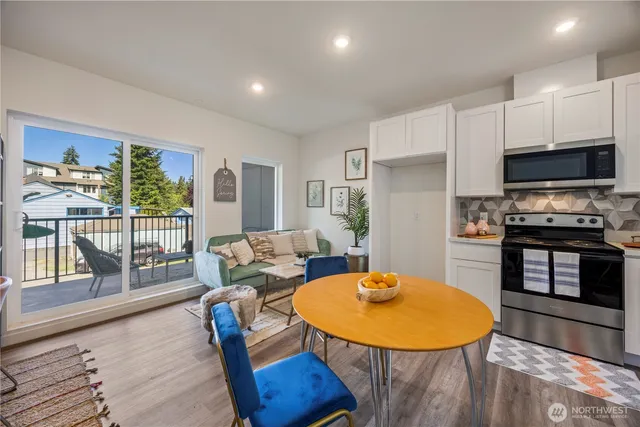 a living room with furniture and a kitchen view