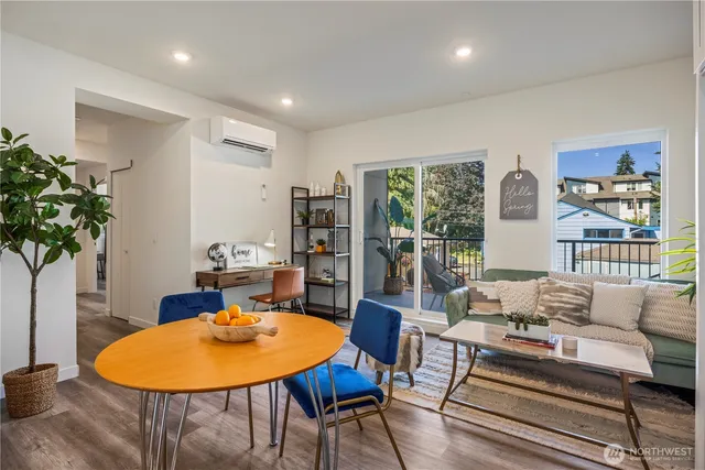 a living room with furniture a table and a potted plant