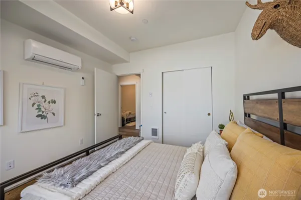 a bedroom with a bed and a painting on the wall