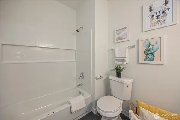 a white toilet sitting next to a bath tub