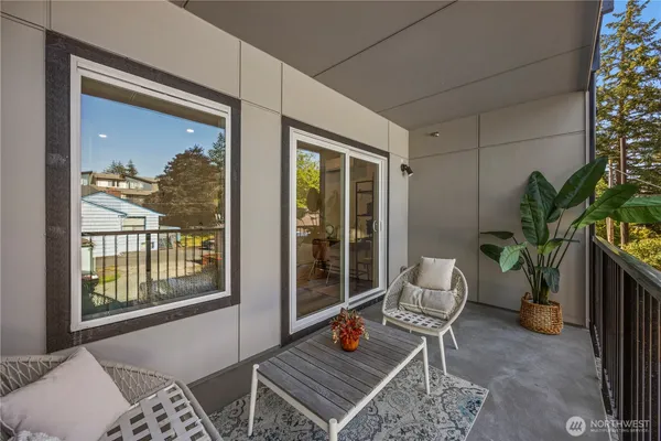 a living room with a couch and a potted plant