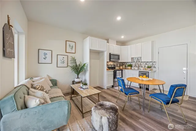 a living room with furniture and kitchen view