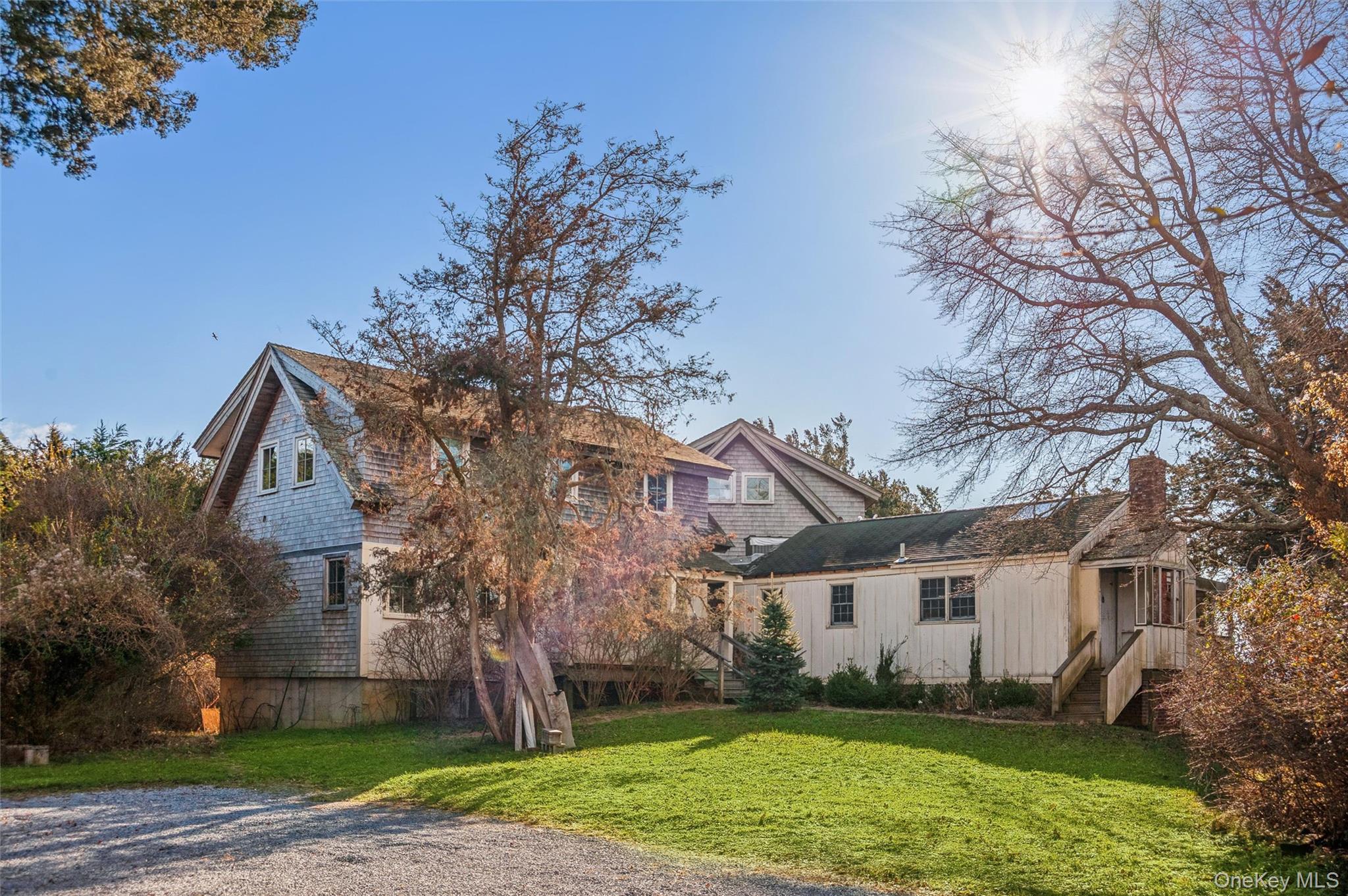 7 Jagger Lane Westhampton, NY 11977 - Photo 1 of 22 Back of property featuring a yard and a chimney