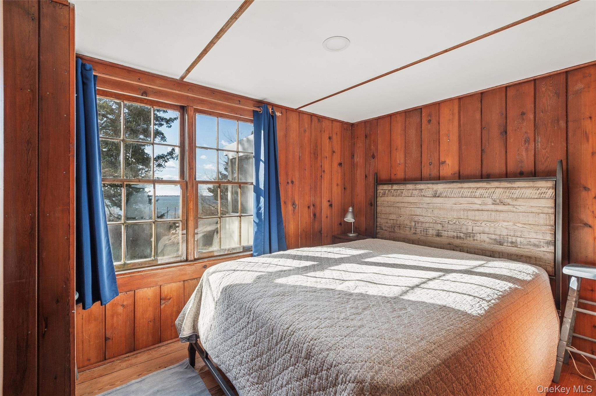 7 Jagger Lane Westhampton, NY 11977 - Photo 18 of 22 Bedroom featuring wood walls and wood finished floors
