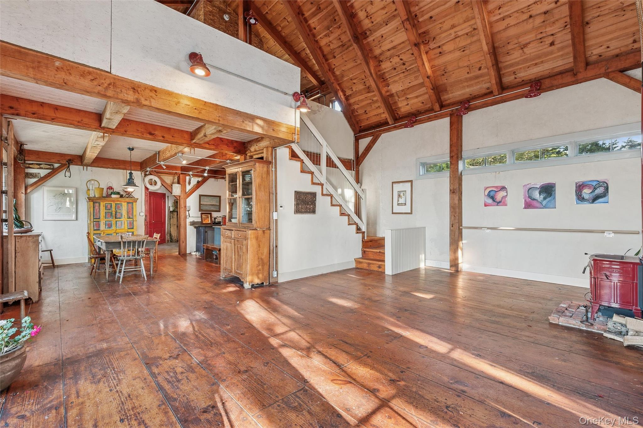 7 Jagger Lane Westhampton, NY 11977 - Photo 6 of 22 Unfurnished living room with a wood ceiling with exposed beams, dark wood-type flooring, stairway, and high vaulted ceiling