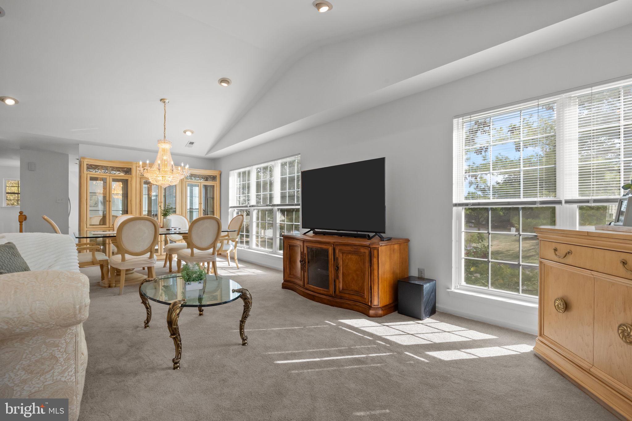 1102 Waterford Road, Unit 1 Yardley, PA 19067 - Photo 13 of 31 a living room with furniture a flat screen tv and floor to ceiling window