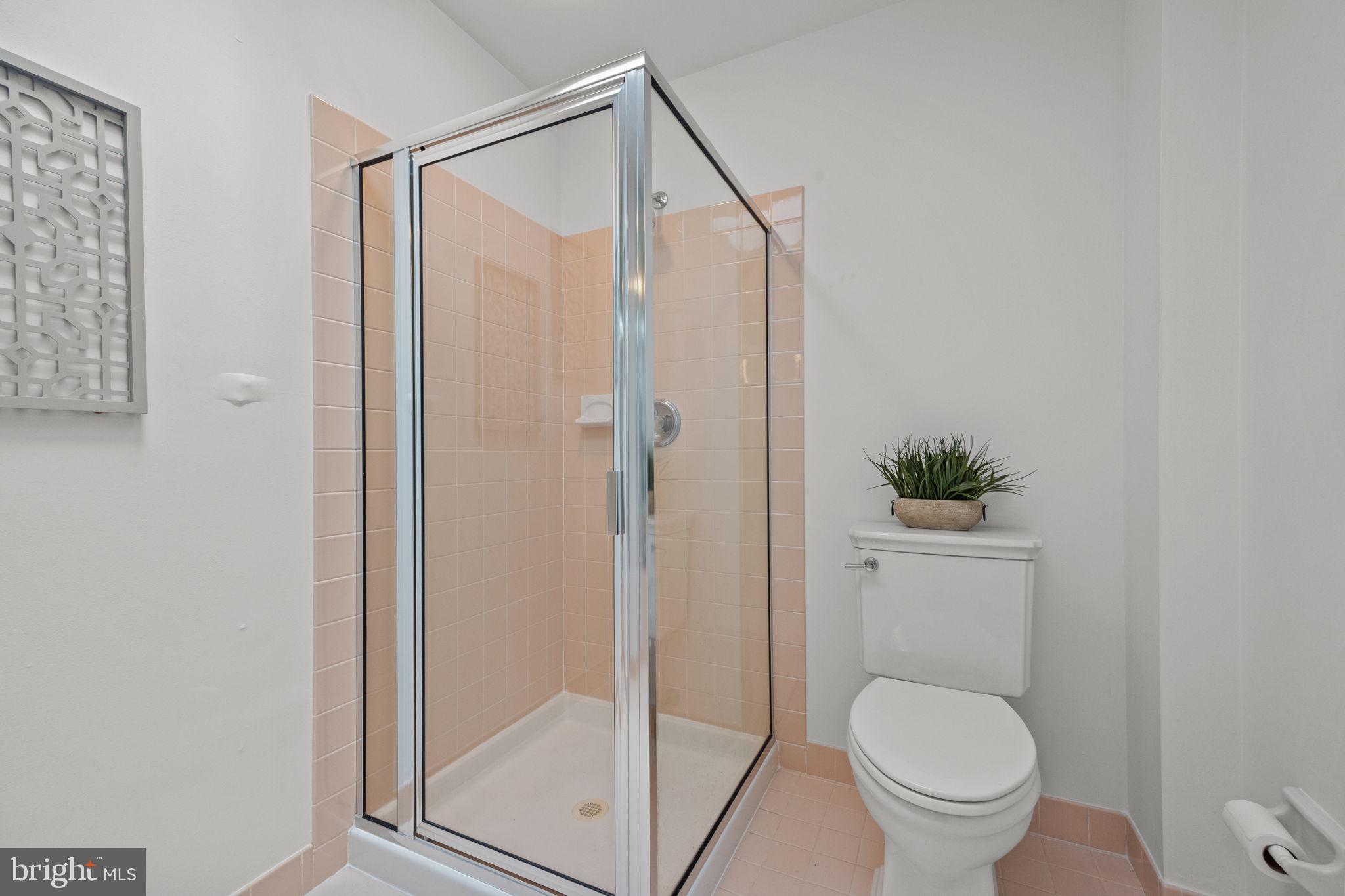 1102 Waterford Road, Unit 1 Yardley, PA 19067 - Photo 20 of 31 a bathroom with a shower a toilet and a mirror
