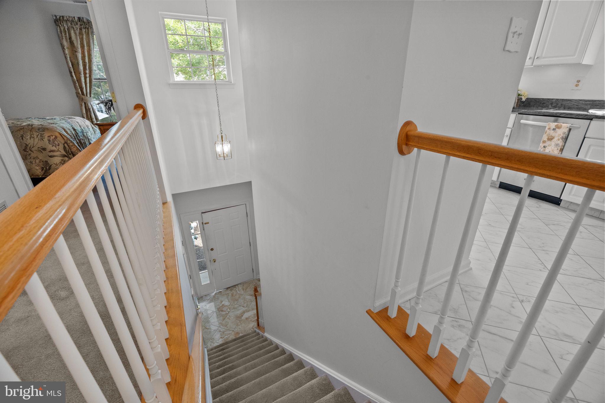 1102 Waterford Road, Unit 1 Yardley, PA 19067 - Photo 26 of 31 a view of a hallway with wooden floor and stairs