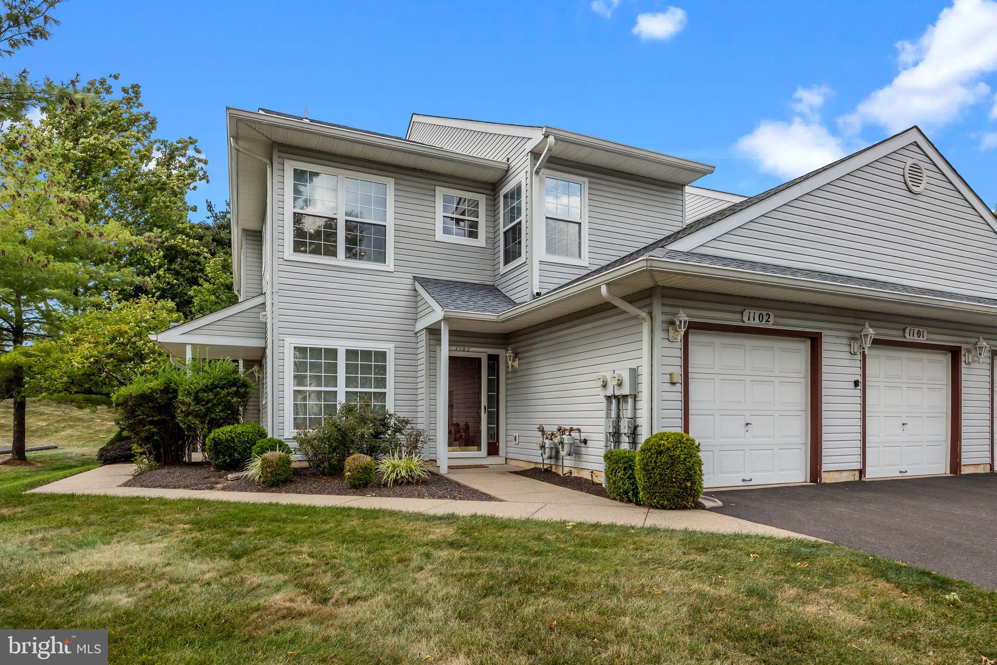 1102 Waterford Road, Unit 1 Yardley, PA 19067 - Photo 28 of 31 a front view of a house with a yard and garage