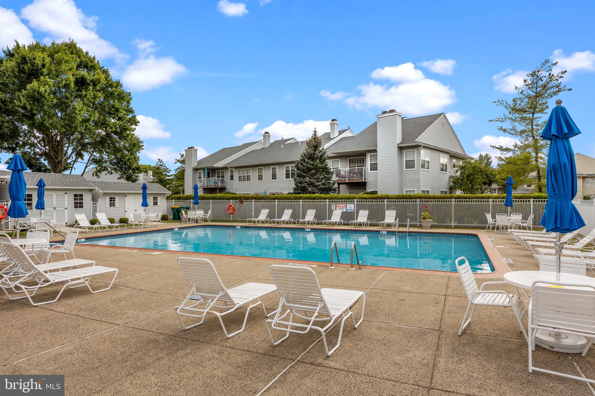 1102 Waterford Road, Unit 1 Yardley, PA 19067 - Photo 31 of 31 a view of a patio with couches table and chairs with wooden floor and fence