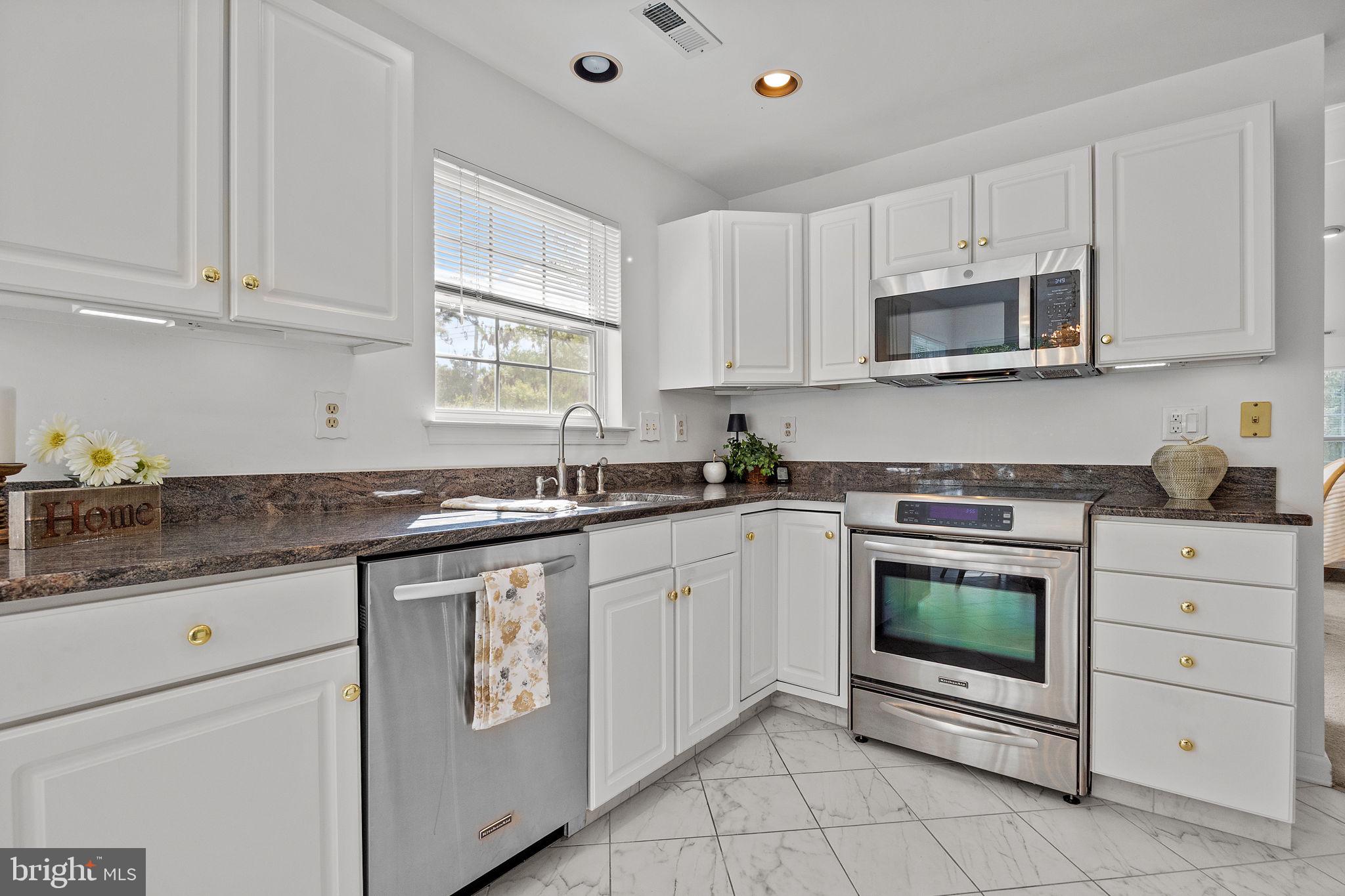 1102 Waterford Road, Unit 1 Yardley, PA 19067 - Photo 5 of 31 a kitchen with white cabinets appliances and a sink