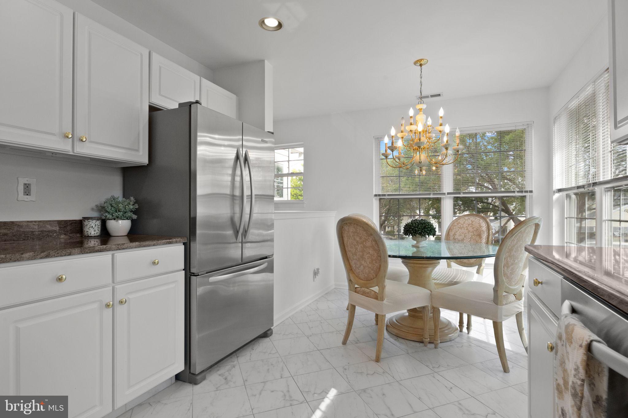 1102 Waterford Road, Unit 1 Yardley, PA 19067 - Photo 6 of 31 a kitchen with stainless steel appliances granite countertop a refrigerator and a wooden cabinets