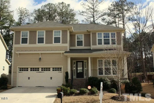 a view of a building with a bench in front of house