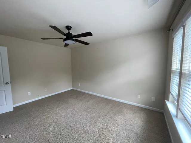 a view of a livingroom with a ceiling fan and window