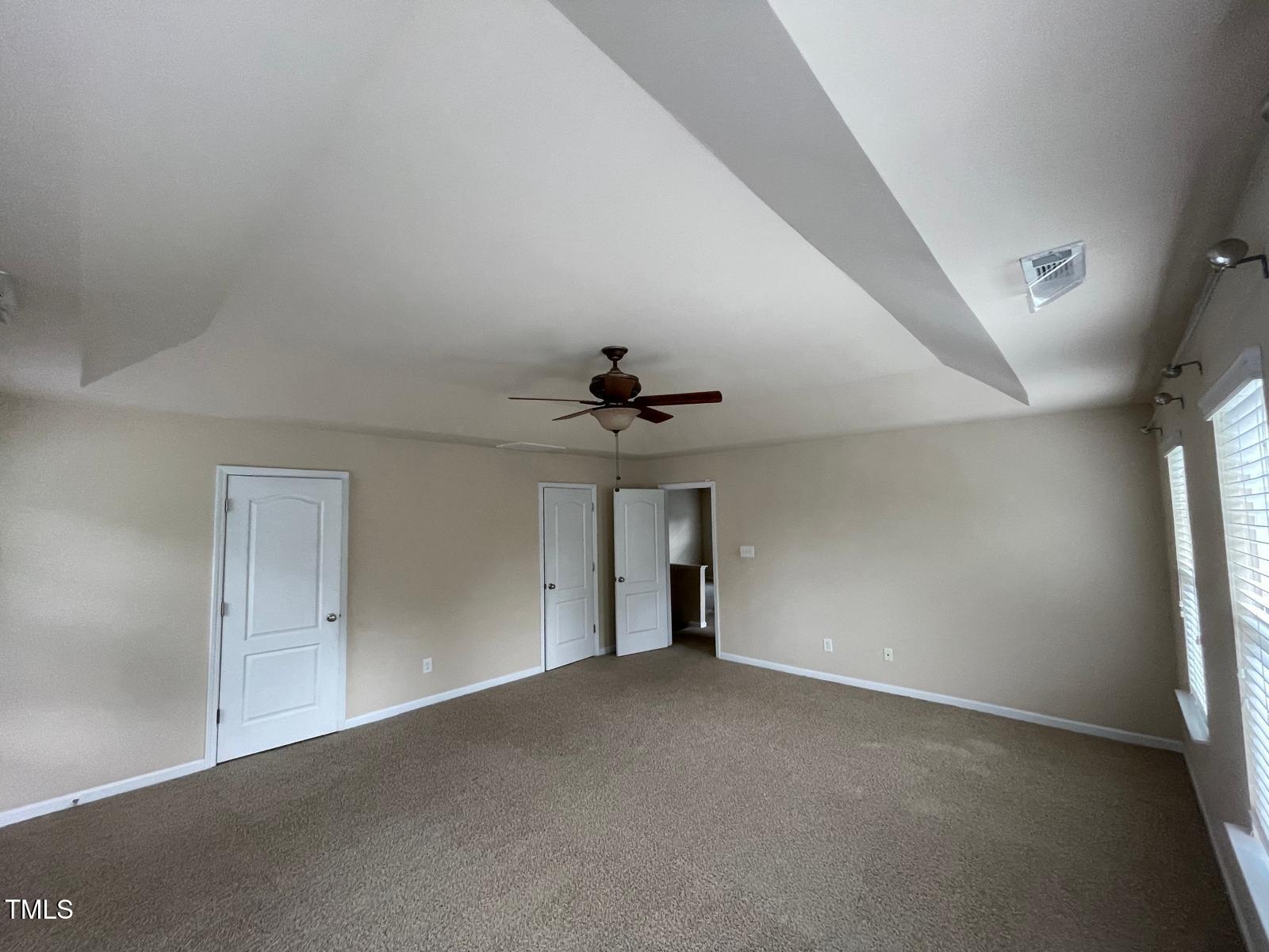 2107 Toad Hollow Trail Apex, NC 27502 - Photo 6 of 28 an empty room with a ceiling fan and window