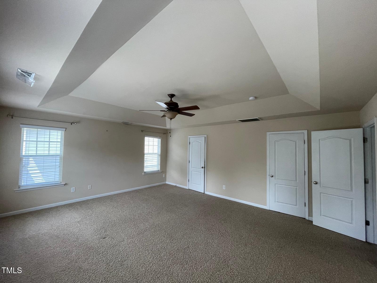 2107 Toad Hollow Trail Apex, NC 27502 - Photo 9 of 28 an empty room with windows and ceiling fan