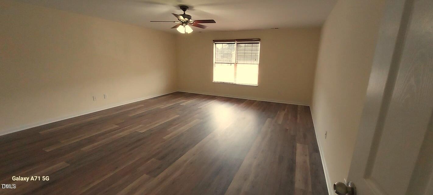 201 Jasper Point Drive Holly Springs, NC 27540 - Photo 11 of 23 a view of empty room with wooden floor and fan