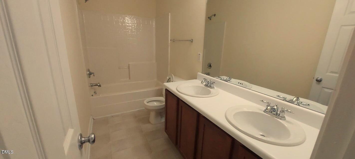 201 Jasper Point Drive Holly Springs, NC 27540 - Photo 12 of 23 a bathroom with a sink a toilet and shower