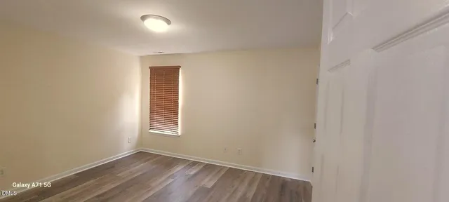 a view of a room with wooden floor and windows