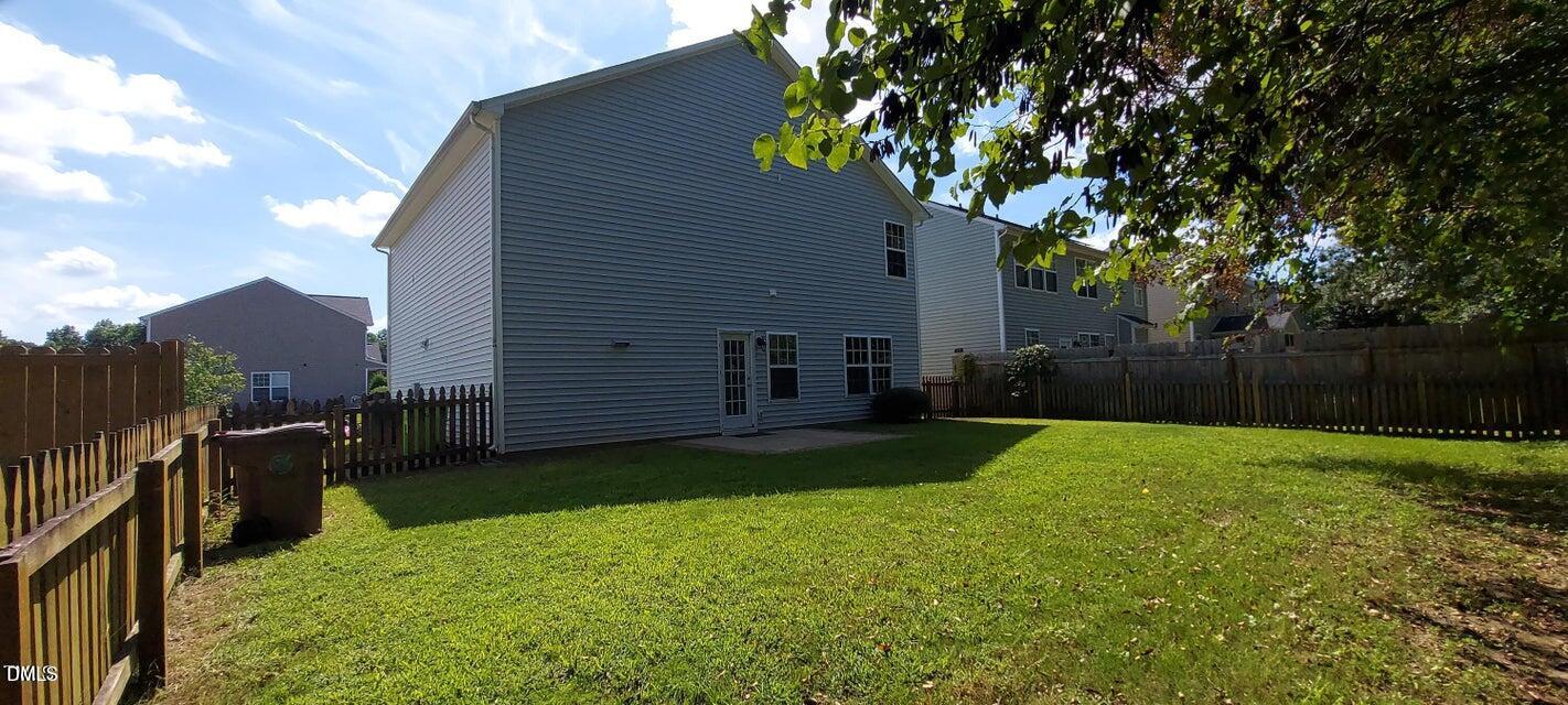 201 Jasper Point Drive Holly Springs, NC 27540 - Photo 19 of 23 a view of a backyard with plants and a large tree
