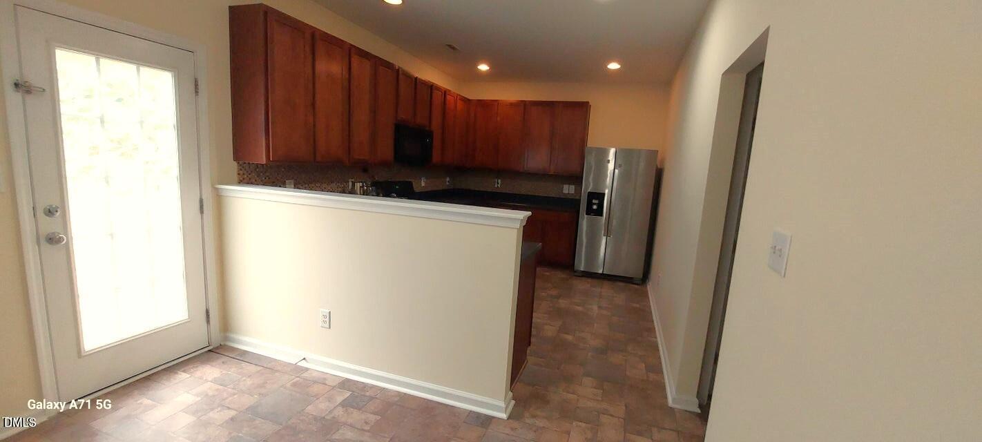 201 Jasper Point Drive Holly Springs, NC 27540 - Photo 5 of 23 a view of kitchen with refrigerator and window