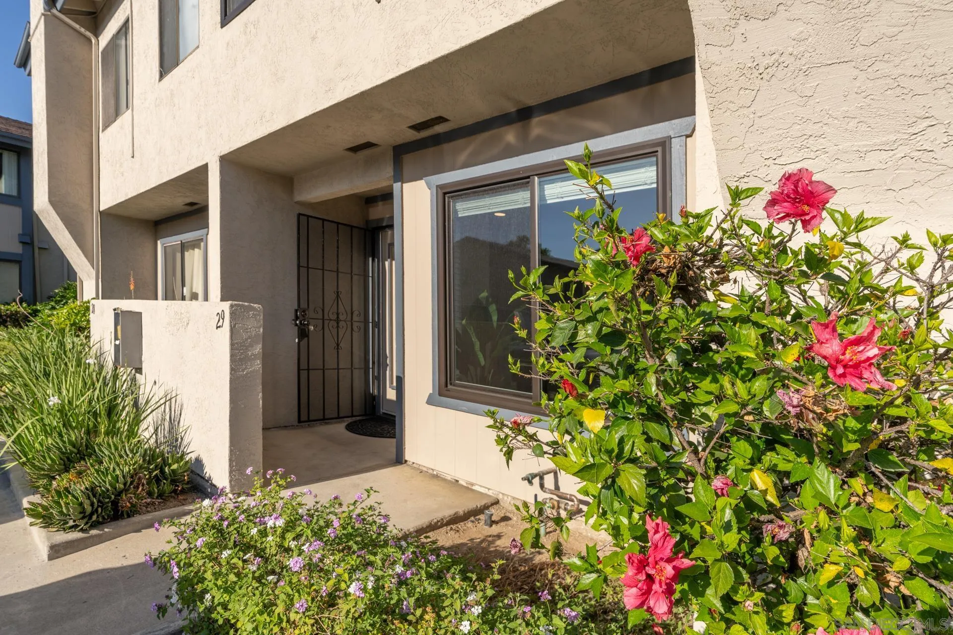 12741 Laurel Street, Unit 29 Lakeside, CA 92040 - Photo 1 of 1 a flower plants in front of a house