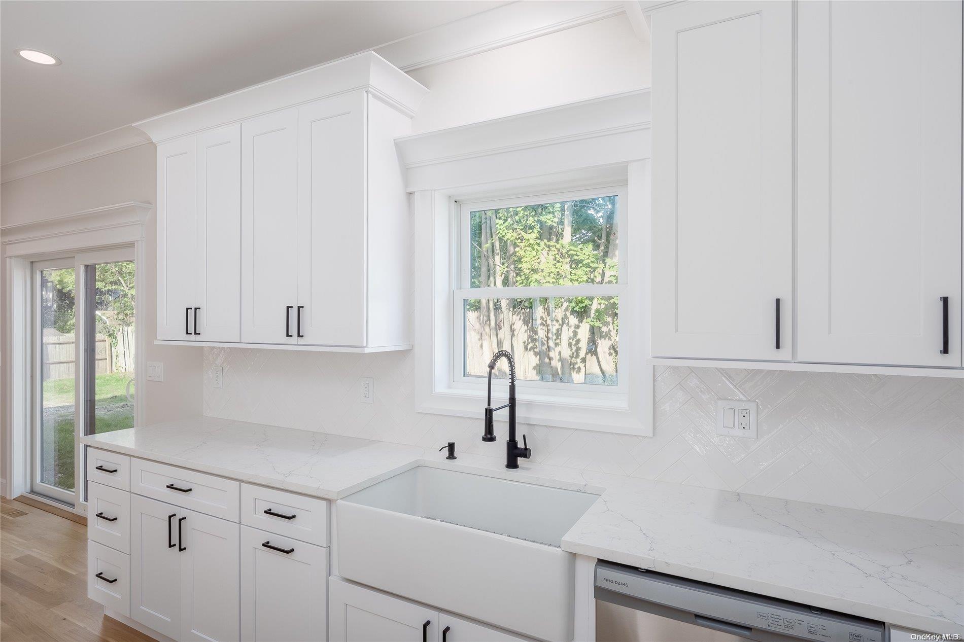 New Constr Pleasant Avenue Centereach, NY 11720 - Photo 7 of 17 a kitchen with white cabinets and a window