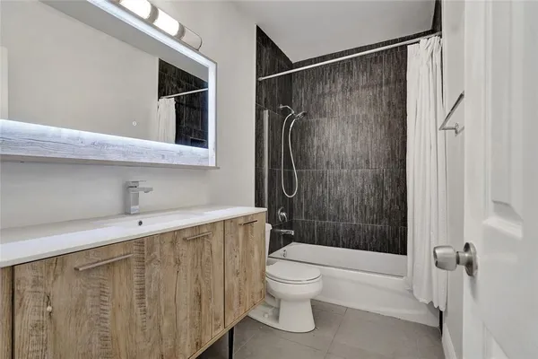 a bathroom with a shower toilet and sink