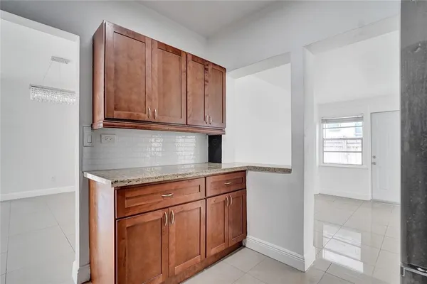 a stove top oven sitting inside of a kitchen