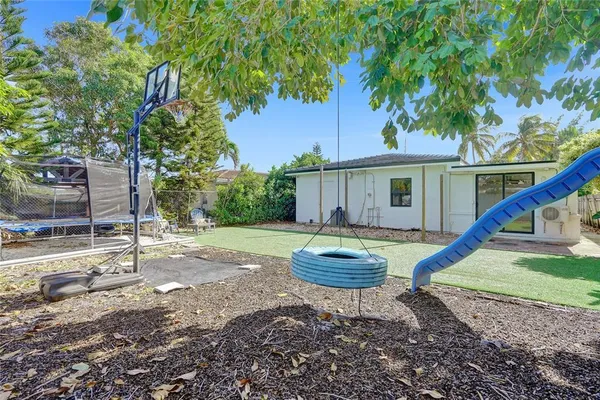 a view of a house with backyard and sitting area