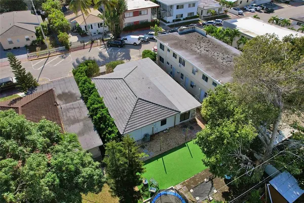 an aerial view of a house with a yard and sitting area
