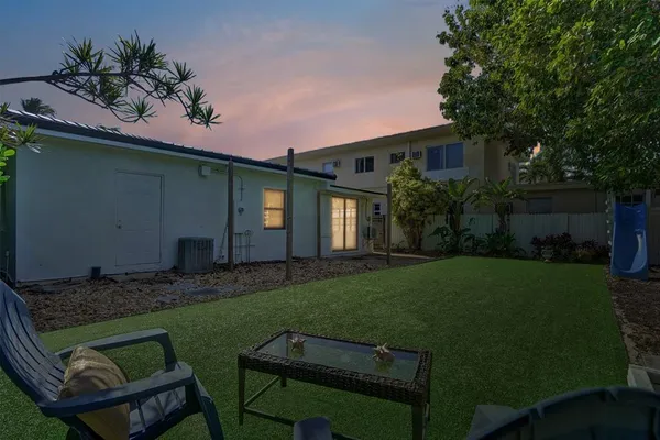 a backyard of a house with table and chairs