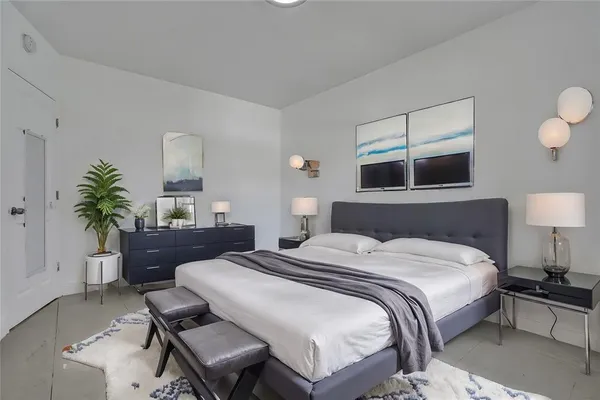 a bedroom with a bed window and couch