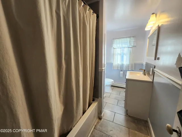 a view of a bathroom with tub and sink
