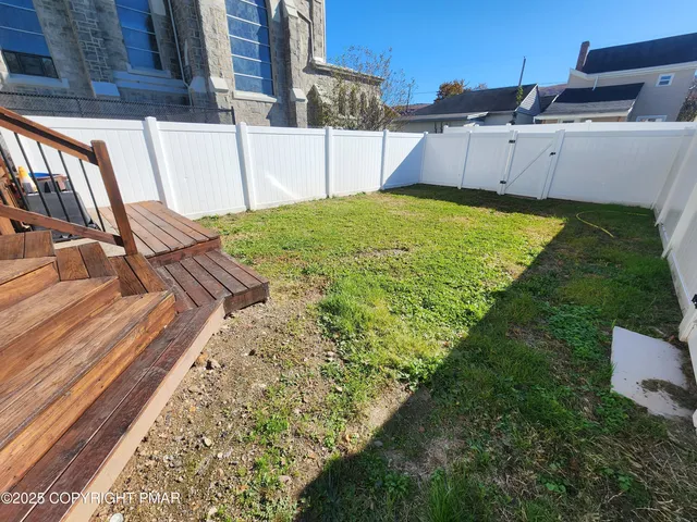 a view of a backyard with sitting area