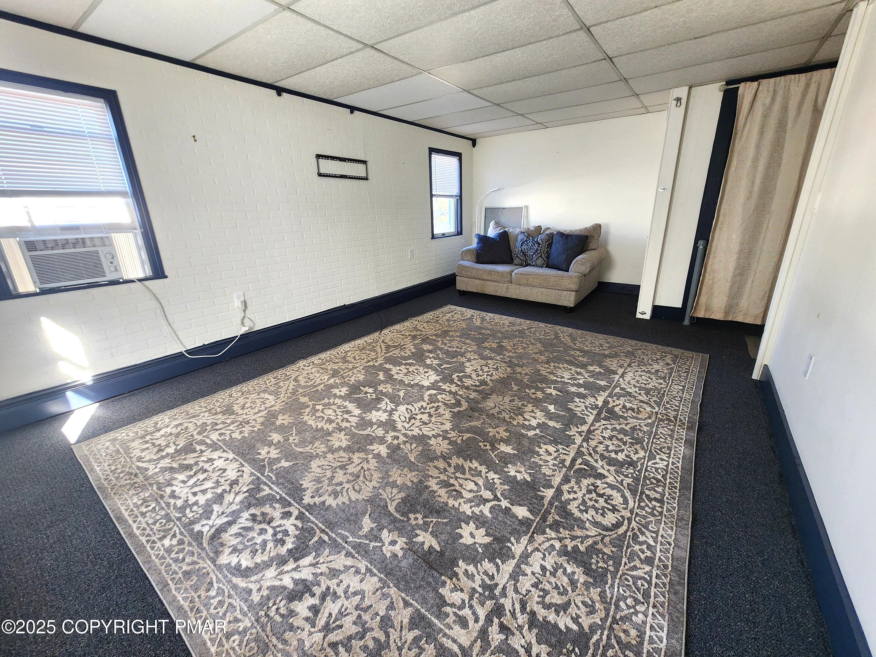 514 North Street, Unit 2 Jim Thorpe, PA 18229 - Photo 7 of 22 a living room with a couch and a rug