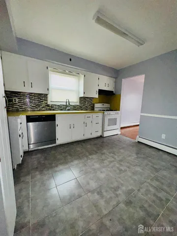 a large kitchen with cabinets and stainless steel appliances