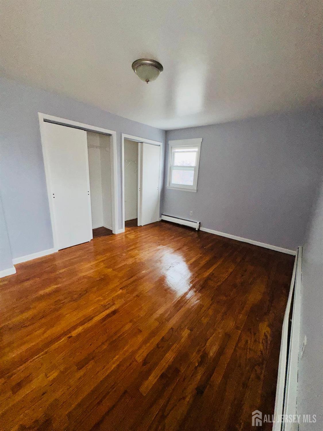 32 Union Place Irvington, NJ 07111 - Photo 13 of 14 a view of an empty room with window and wooden floor