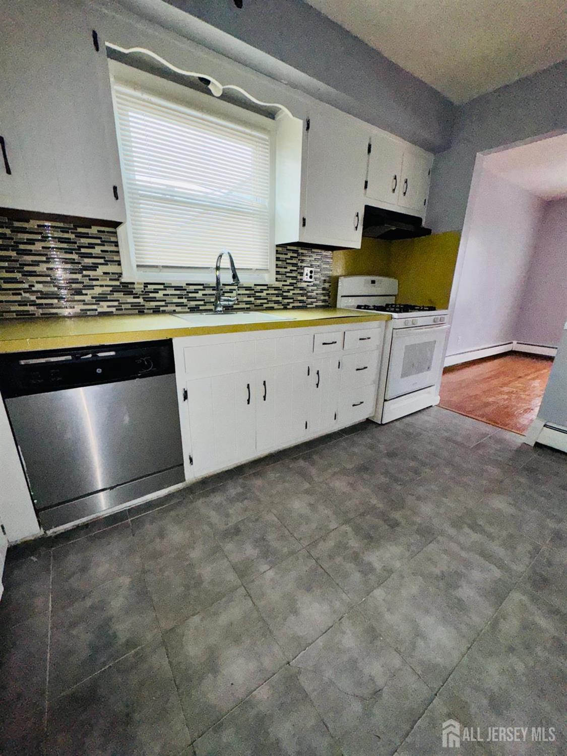 32 Union Place Irvington, NJ 07111 - Photo 3 of 14 a view of kitchen with granite countertop window and sink