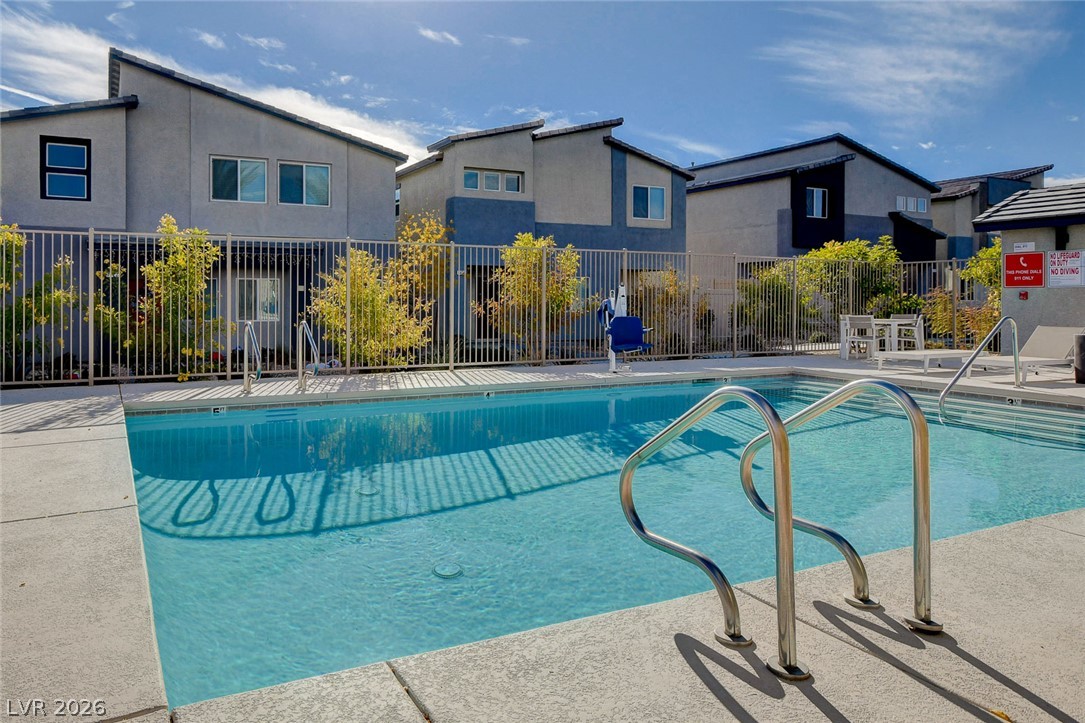 7330 North Decatur Boulevard, Unit 6 North Las Vegas, NV 89084 - Photo 27 of 42 A sparkling pool with accessibility features offers a refreshing escape amidst modern community residences.
