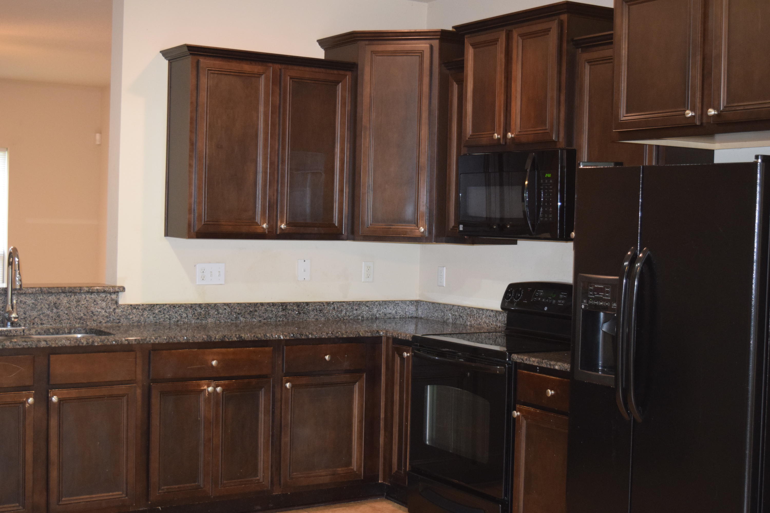 662 Red Fern Road Crestview, FL 32536 - Photo 5 of 9 a kitchen with granite countertop wooden cabinets and a refrigerator