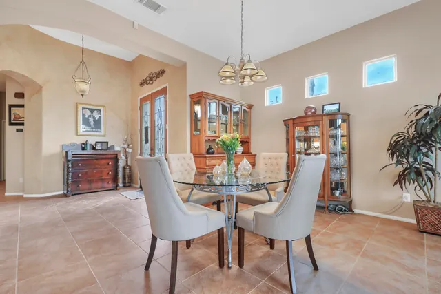 a view of a dining room with furniture and chandelier