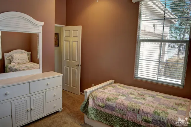 a bedroom with a bad and dresser