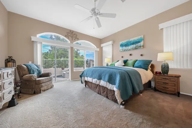 a spacious bedroom with a bed and glass walk in closet