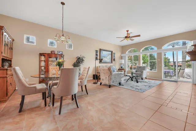 a view of a livingroom with furniture a chandelier and wooden floor