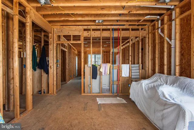 a spacious bedroom with a bed and a window